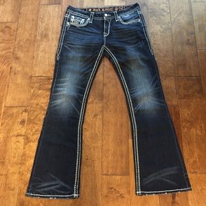 Boot cut, dark wash with distressing Rock Revival